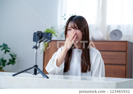 Sad young woman filming a video 123465932