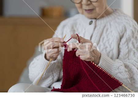 The hands of an 80-year-old woman knitting The hands of an 80-year-old woman knitting 123466730