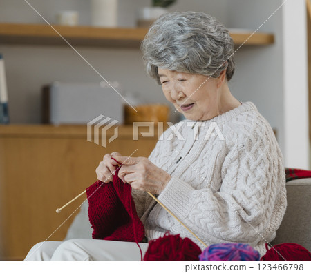 A woman in her 80s knitting A woman in her 80s knitting 123466798