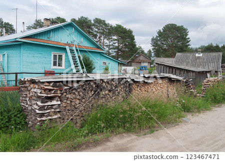 Country wooden house with pile of firewood Country wooden house with pile of firewood 123467471