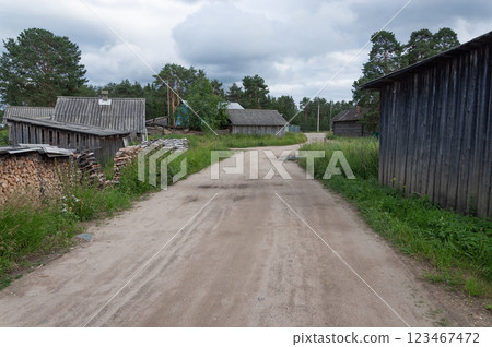 Country road, sheds and firewood 123467472