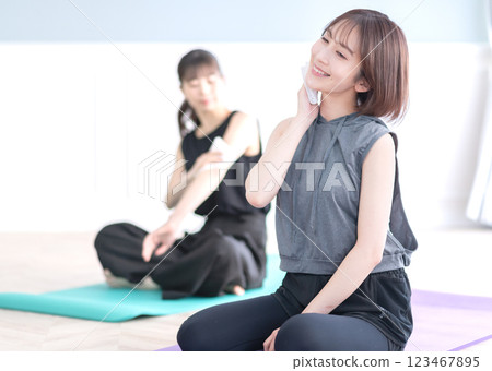 Young woman wiping sweat with a towel 123467895