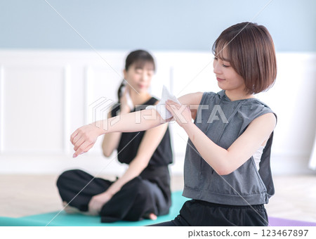 Young woman wiping sweat with a towel 123467897