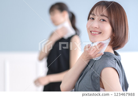 Young woman wiping sweat with a towel 123467988