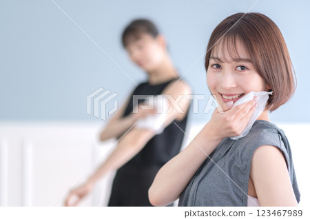 Young woman wiping sweat with a towel 123467989