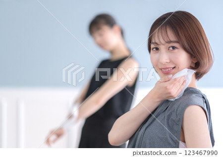 Young woman wiping sweat with a towel 123467990