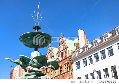 The famous Stork fountain and traditional old houses on the street in the center of Copenhagen. 123470555