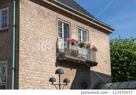Cozy balcony with flowers in a brick house. 123470557