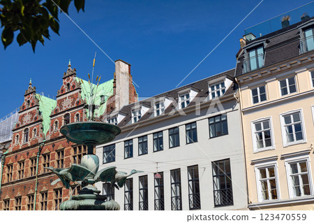 The famous Stork fountain and traditional old houses on the street in the center of Copenhagen. The famous Stork fountain and traditional old houses on the street in the center of Copenhagen. 123470559