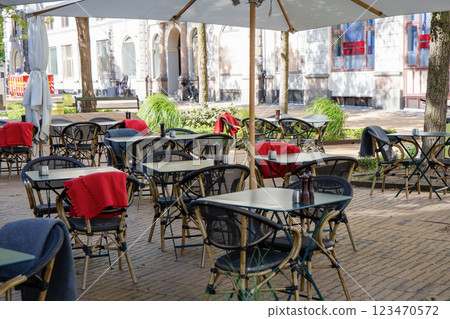 Cozy street cafe with empty tables on a summer day. Cozy street cafe with empty tables on a summer day. 123470572