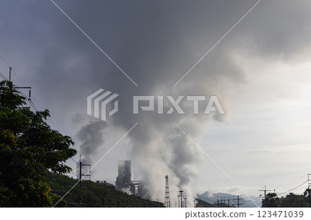 Power plant high pipes with black smoke moving up polluting atmosphere at sunrise. 123471039