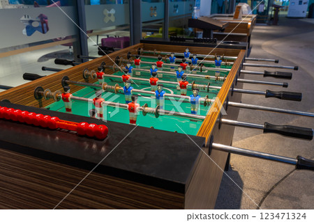 Retro table soccer with wooden miniature figurines of players on metal bars 123471324