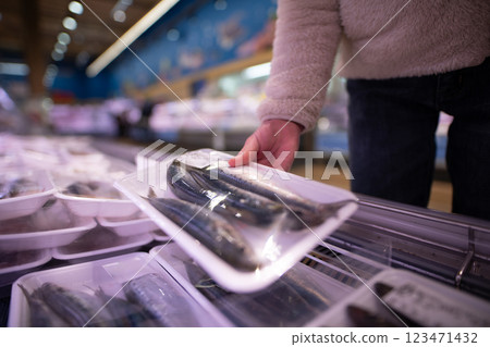Children's hands picking up fish in a supermarket 123471432