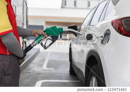 Man Refill and filling Oil Gas Fuel at station. Gas station - refueling.	 123471481