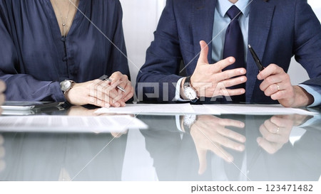 Business partners or lawyers are reviewing contract terms during a meeting, negotiating and making decisions together. Business people concept, close up view 123471482