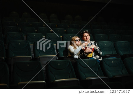 Couples enjoy a private moment in a nearly empty movie theater Couples enjoy a private moment in a nearly empty movie theater 123471637