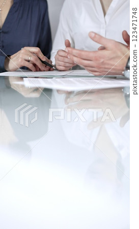Business people are reviewing contract terms during a meeting, negotiating and making decisions together, vertical close up view. Copy space area 123471748