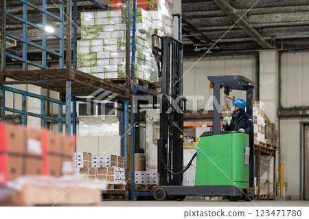 Man driving a forklift in a refrigerated warehouse 123471780