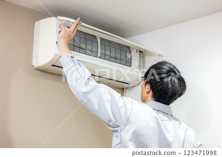 Workers inspecting air conditioners 123471998