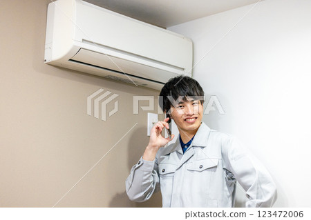 Workers inspecting air conditioners Workers inspecting air conditioners 123472006