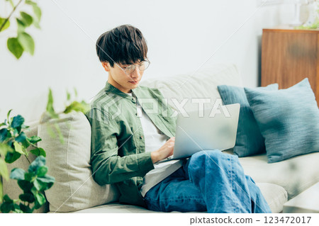Young man using a computer at home 123472017