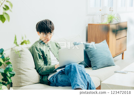 Young man using a computer at home 123472018