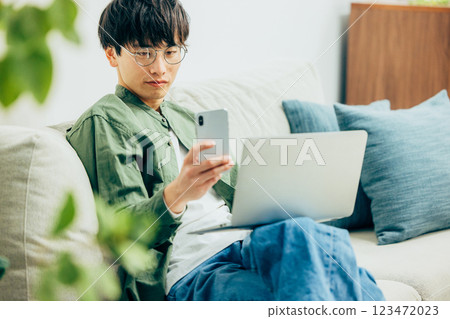 Men looking at smartphones Men looking at smartphones 123472023