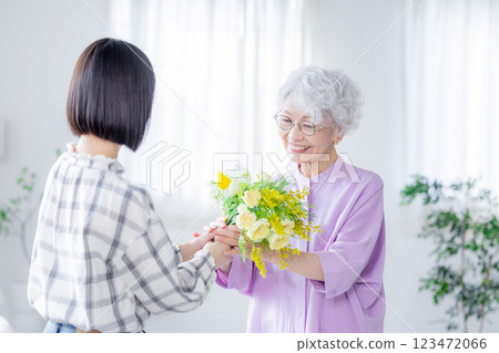 Woman handing over a bouquet of flowers on Respect for the Aged Day Woman handing over a bouquet of flowers on Respect for the Aged Day 123472066