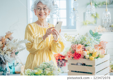 Senior woman taking a photo with a smartphone 123472078