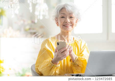 Senior woman operating a smartphone Senior woman operating a smartphone 123472085
