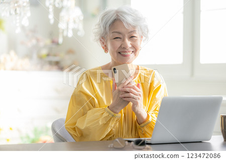 Senior woman operating a smartphone 123472086