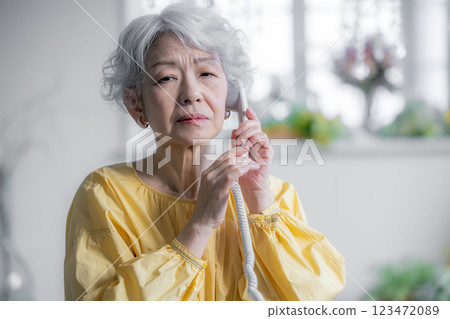Senior woman talking on landline phone Senior woman talking on landline phone 123472089