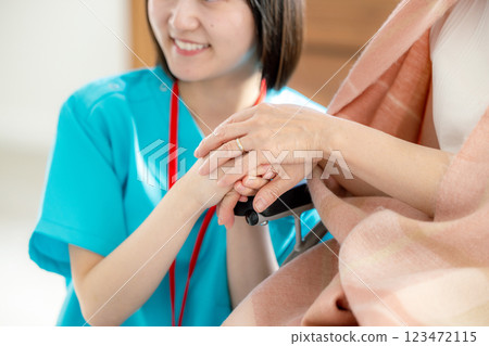 Senior woman in wheelchair and nursing staff 123472115