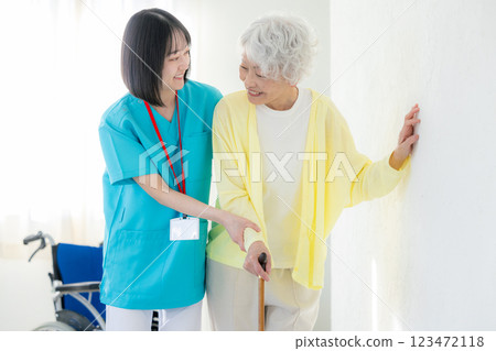 Rehabilitation: Young and senior women working in a nursing home Rehabilitation: Young and senior women working in a nursing home 123472118