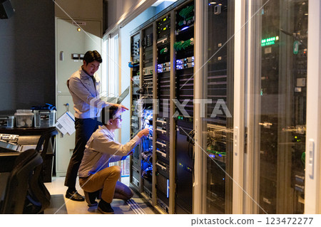 Engineers having a meeting in front of the server 123472277