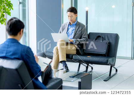 Businessmen working in the lobby Businessmen working in the lobby 123472355
