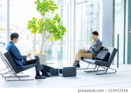 Businessmen working in the lobby Businessmen working in the lobby 123472358