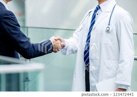 Doctor and businessman shaking hands Doctor and businessman shaking hands 123472441