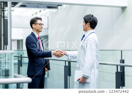 Doctor and businessman shaking hands Doctor and businessman shaking hands 123472442