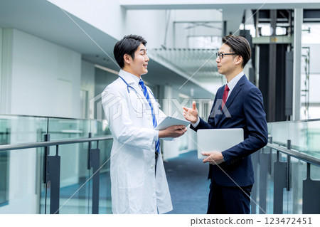 Doctors and businessmen in white coats meeting at hospital 123472451