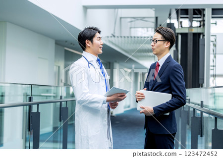 Doctors and businessmen in white coats meeting at hospital 123472452