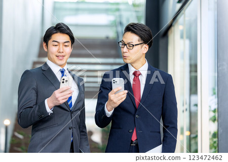 A man in a suit with a smartphone A man in a suit with a smartphone 123472462