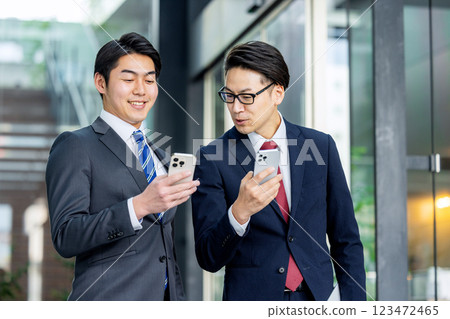 A man in a suit with a smartphone 123472465