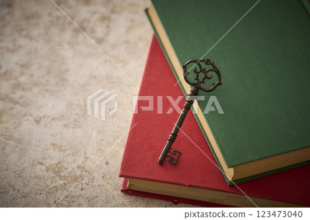 Antique key on top of an old book 123473040