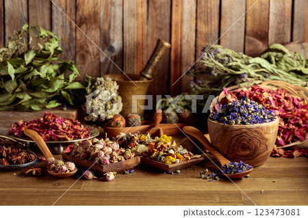 Various dried medicinal plants, herbs, and flowers on an old wooden background. Various dried medicinal plants, herbs, and flowers on an old wooden background. 123473081