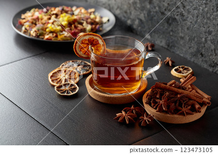 Cup of herbal tea with ingredients and slices of dried orange slices. Cup of herbal tea with ingredients and slices of dried orange slices. 123473105