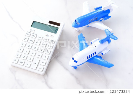Calculator and airplane, image of rising airfares and soaring travel costs Calculator and airplane, image of rising airfares and soaring travel costs 123473224