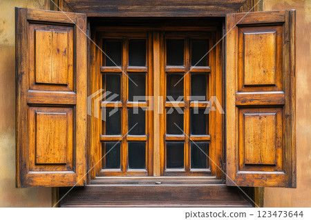 Wooden ancient window. Window with shutters, patterned on the wall of the old wooden house. 123473644