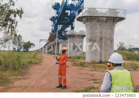 Engineer surveyor team Use drone for operator inspecting and survey construction site Engineer surveyor team Use drone for operator inspecting and survey construction site 123473803