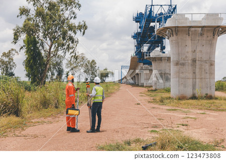 Engineer surveyor team Use drone for operator inspecting and survey construction site 123473808